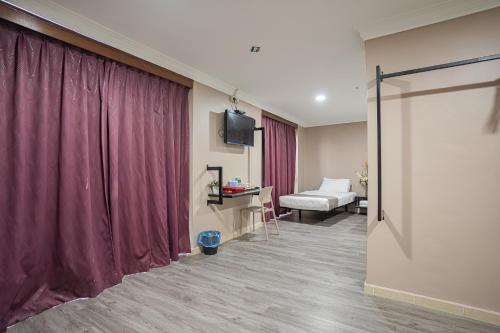a room with a red curtain and a bed at HOTEL 28 RAPID in Kuala Lumpur
