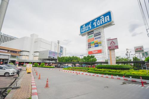 a parking lot with orange cones in front of a building at Asia Airport Hotel in Bangkok
