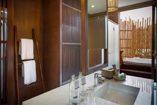 a bathroom with a sink and a tub at Prana Resort Nandana in Bangrak Beach