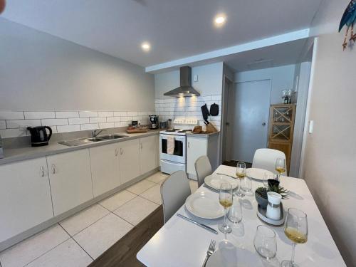 a kitchen with a table with wine glasses on it at Park Views, Close to town in Queenstown