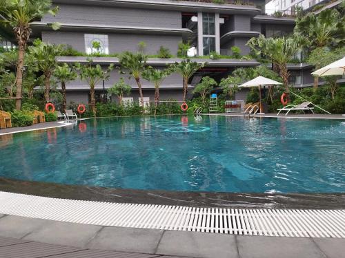 a large swimming pool in front of a building at Sam's homestay- Swan lake studio apartment in Kim Quan