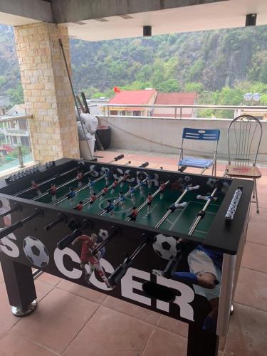 a large table with a soccer game on it at Phong Nha Jasmine Hostel & Roof Top Bar in Phong Nha