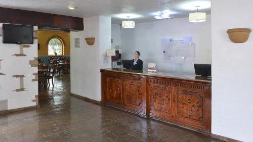 a man sitting at a bar in a restaurant at Holiday Inn Express Morelia by IHG in Morelia