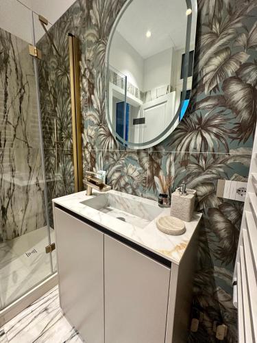a bathroom with a sink and a mirror at Gmaison in Milan