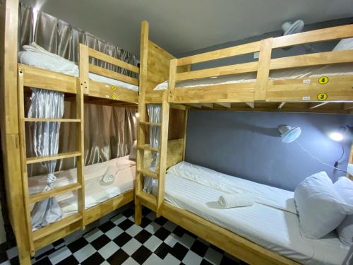 two bunk beds in a room with a checkered floor at The 60 in George Town
