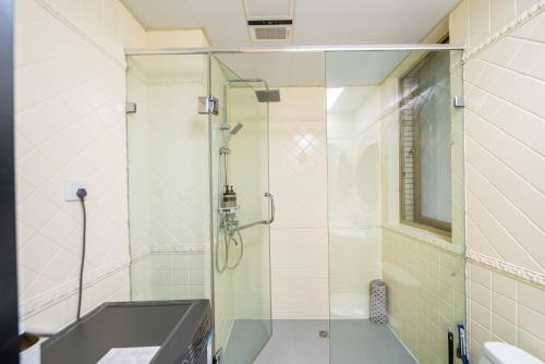 a glass shower in a bathroom with a sink at Shanghai YD B&B - Yu Garden Bund Store, 400m near Yu Garden subway in Shanghai