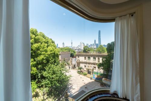 a window with a view of a city at Shanghai Yi Du B&B - Yu Garden Bund Store, 400m near Yu Garden subway in Shanghai