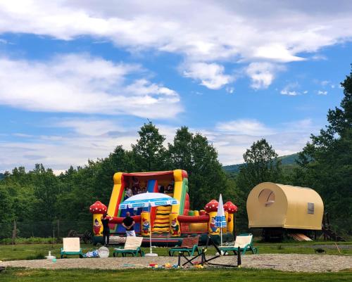 a park with a playground with a play equipment at Carul cu Stele-Glamping 
