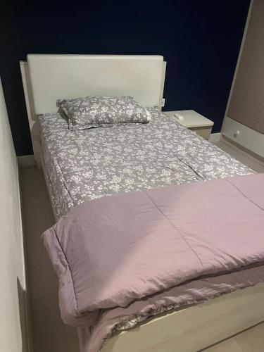 uma cama num quarto com um edredão roxo em Semayang Asya em Jakarta