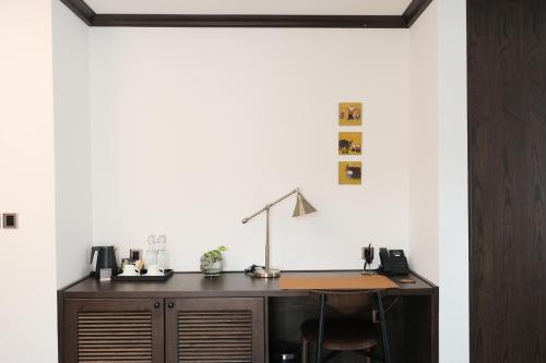 an office with a desk with a lamp on it at Paul Chabot Hotel in Hai Phong