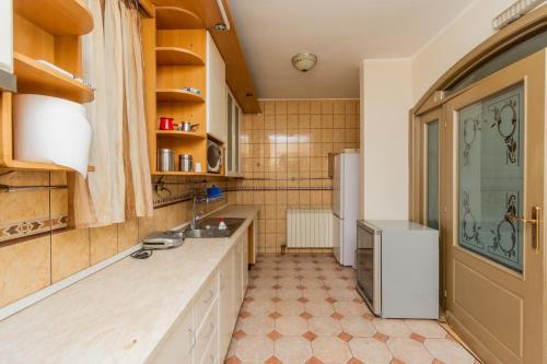 a kitchen with a sink and a refrigerator at Hotel Fobra in Podgorica