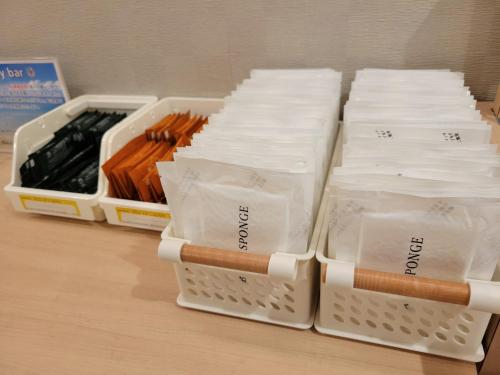 a group of white plastic containers filled with matches at Smile Hotel Osaka Tennoji in Osaka