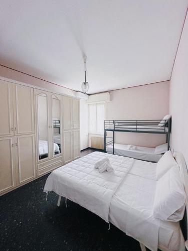 a bedroom with a large white bed and cabinets at UN BEL POSTO AL MARE in Savona