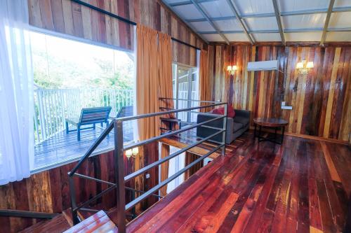 a room with wooden walls and a staircase in a house at Woodcookies Guesthouse in Pangkor