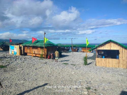 a group of buildings with green roofs and flags at Villa Rosita Peebles Beach in Surigao