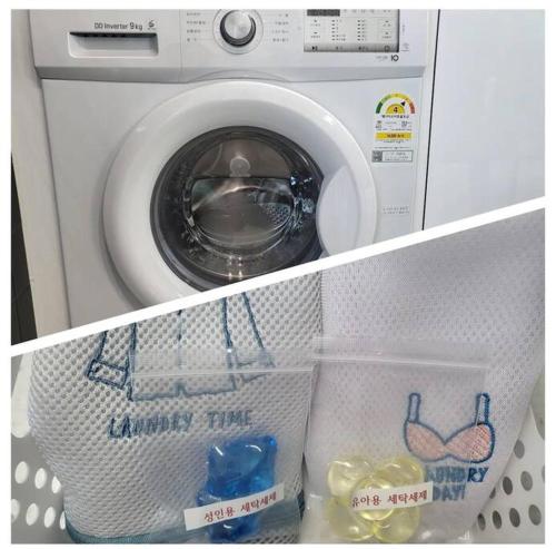 a washing machine is sitting in a shelf at The Gangneung Ocean Stay in Gangneung