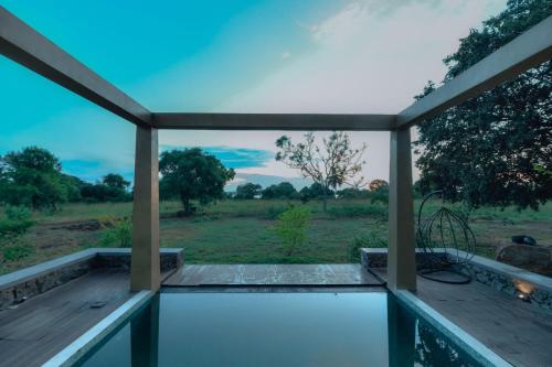 a view from the balcony of a house with a view of a field at The Villa Lakeshore in Anuradhapura