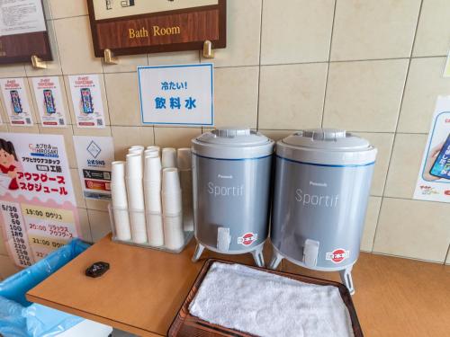two trash cans sitting on top of a table at Asahi sauna Capsule Inn Hirosaki in Hirosaki