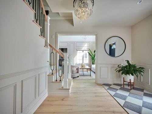 a hallway with a staircase and a chandelier at ポーラーリゾート軽井沢サンジェルマン in Oiwake