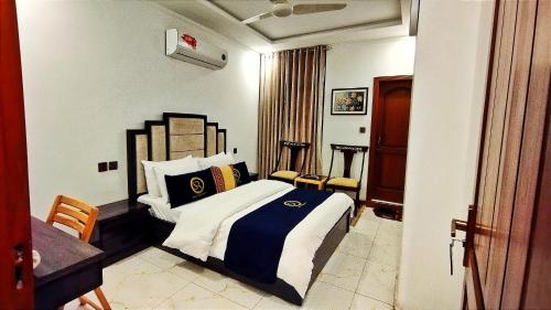 a bedroom with a bed and a table and chairs at Hotel Swat Rezidor by Khan Familia Travels in Swat