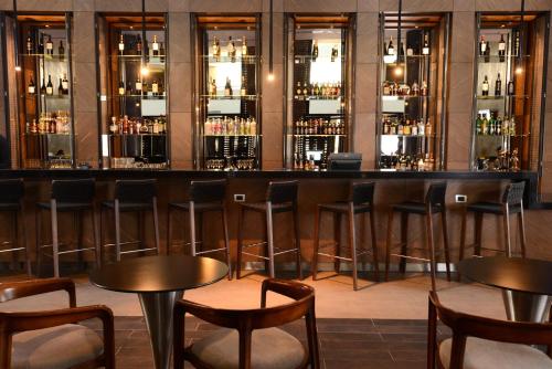 a bar with chairs and tables in a room at Holiday Inn Santiago - Airport Terminal by IHG in Santiago