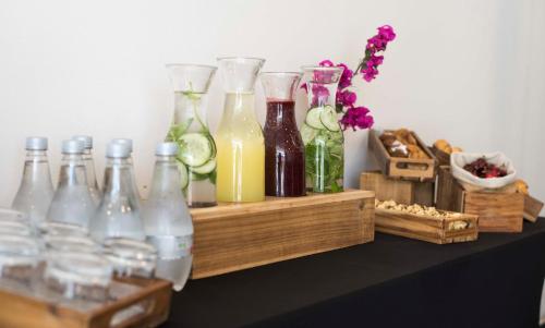 a group of bottles sitting on a table with drinks at Holiday Inn Santiago - Airport Terminal by IHG in Santiago