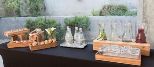 a table with bottles and glasses on top of it at Holiday Inn Santiago - Airport Terminal by IHG in Santiago