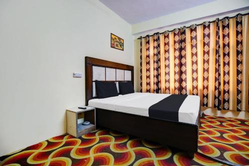 a bedroom with a bed and a carpet at OYO Hotel Basera in Shimla