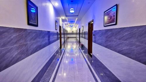 a hallway with blue walls and a bowling alley at Hotel Swat Rezidor by Khan Familia Travels in Swat