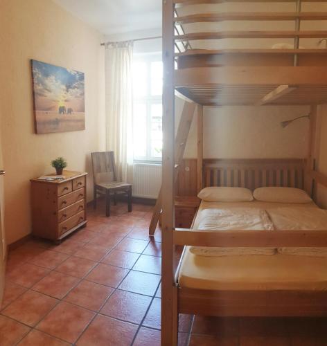 a bedroom with a bunk bed and a desk at Weser-Aktivhotel-Corvey in Höxter