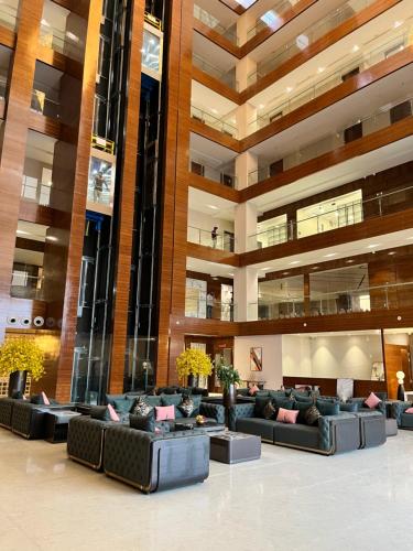 a large lobby with couches in a building at VITS Satyajeet Karad in Karad