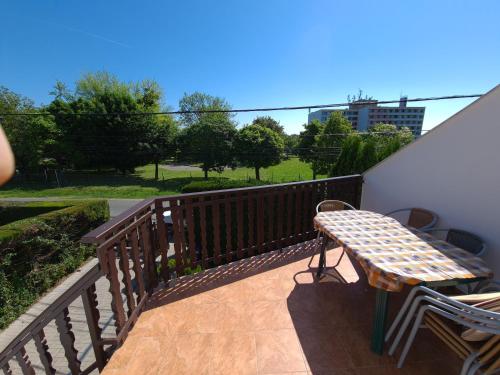 a wooden bench sitting on a balcony at Balázs Apartman in Zalakaros