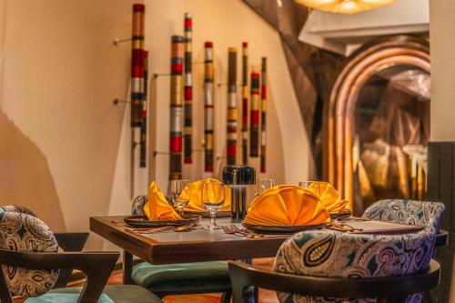 a dining room with a table with chairs and wine glasses at Novotel Kolkata Hotel and Residences in Kolkata