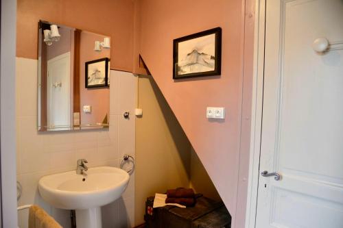 a bathroom with a sink and a stairway at Le Concept-Studio in Perrigny-sur-Armançon