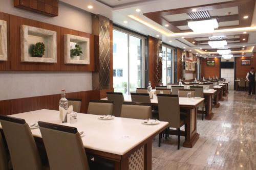 a dining room with tables and chairs in a restaurant at Sea Resort in Digha