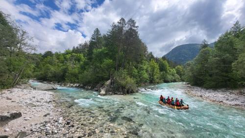 a group of people in a raft on a river at Apartment Luka at Soča & Koritnica confluence in Bovec