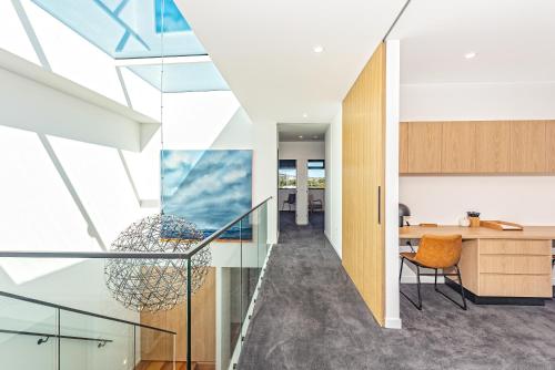 an open staircase in a house with glass ceilings at Award-winning beachfront luxury in Cremorne in Sandford