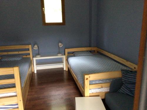 a room with two bunk beds and a chair at Chambres privées dans maison individuelle in Saint-Romain-au-Mont-dʼOr