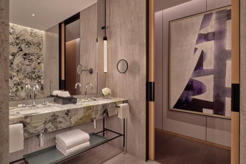 uma casa de banho com 2 lavatórios e um espelho grande em Park Hyatt Changsha em Changsha