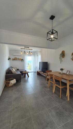 a living room with a table and a couch at Lana's Place in Kalamos