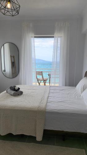 a bedroom with a large bed and a mirror at Lana's Place in Kalamos