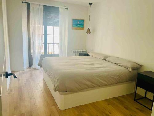 a bedroom with a large bed in a room at Casa Carmela in Fuenmayor