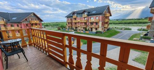 a balcony with a view of a house at Apartment FIMM in Veľká Lomnica
