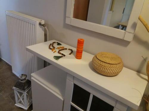 a white counter with a bottle and a basket on it at Paros Hospitality by the sea in Kampos Paros