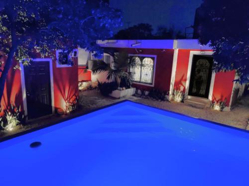 a pool in front of a house at night at Colonial Villa in Merida Centro 4BR 3BA Private Pool Near Paseo de Montejo in Mérida