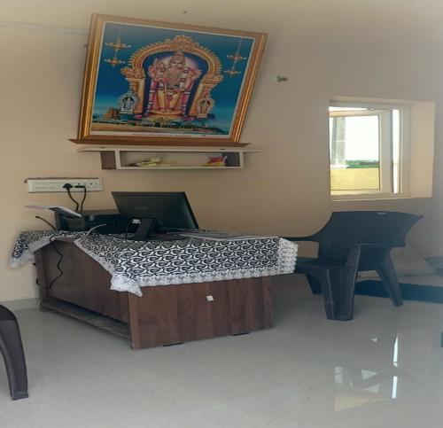 Un dormitorio con una cama con una computadora portátil encima. en Arumugam Residency AC, en Tiruchchendūr