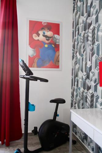 a room with a treadmill and a picture of micrats at Lux Penthouse Apartment 3 bedrooms Quatre Bornes in Quatre Bornes