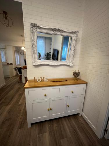 a white dresser with a mirror on a wall at Piso recién reformado en el centro de Santander, zona estaciones in Santander