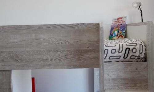 a wooden bunk bed in a room with a book at Lux Penthouse Apartment 3 bedrooms Quatre Bornes in Quatre Bornes