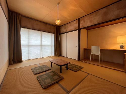a living room with a table and a window at AKUNOURA HUIS - Vacation STAY 10922 in Nagasaki